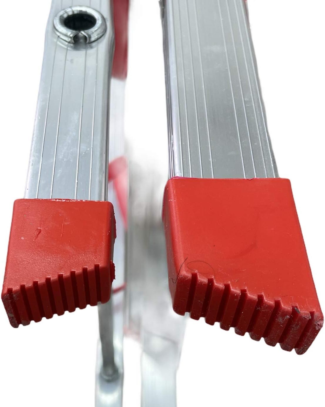 Close-up of the sturdy red rubber feet on a high-quality aluminum ladder, designed for stability and safety.