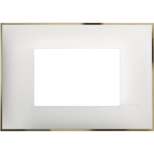 Bticino 3-module switch plate in white and gold, dimensions 86mm height and 122mm width, stylish electrical accessory.