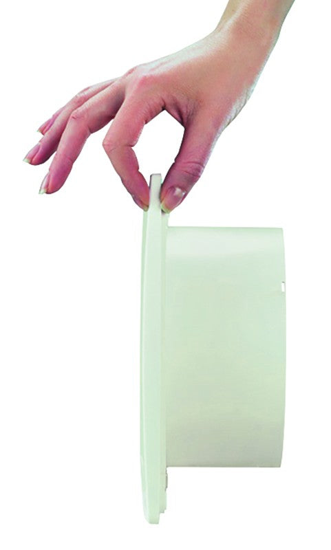 Hand holding the edge of a Vortice Ultrapiatto wall-mounted extractor fan, showcasing its slim design.