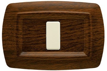 Placca Tondo' 1 Posto Legno Scuro FEB 2591/LS with a light switch button on a dark wood background.